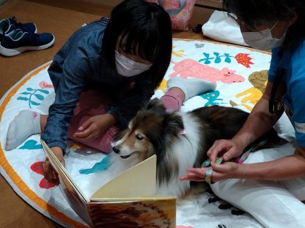 犬への本の読み聞かせの様子（写真提供：品川区立大崎図書館分館）